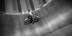 Motorcycle stuntman in a silo Wall of Death, Udon Thani, Thailand.